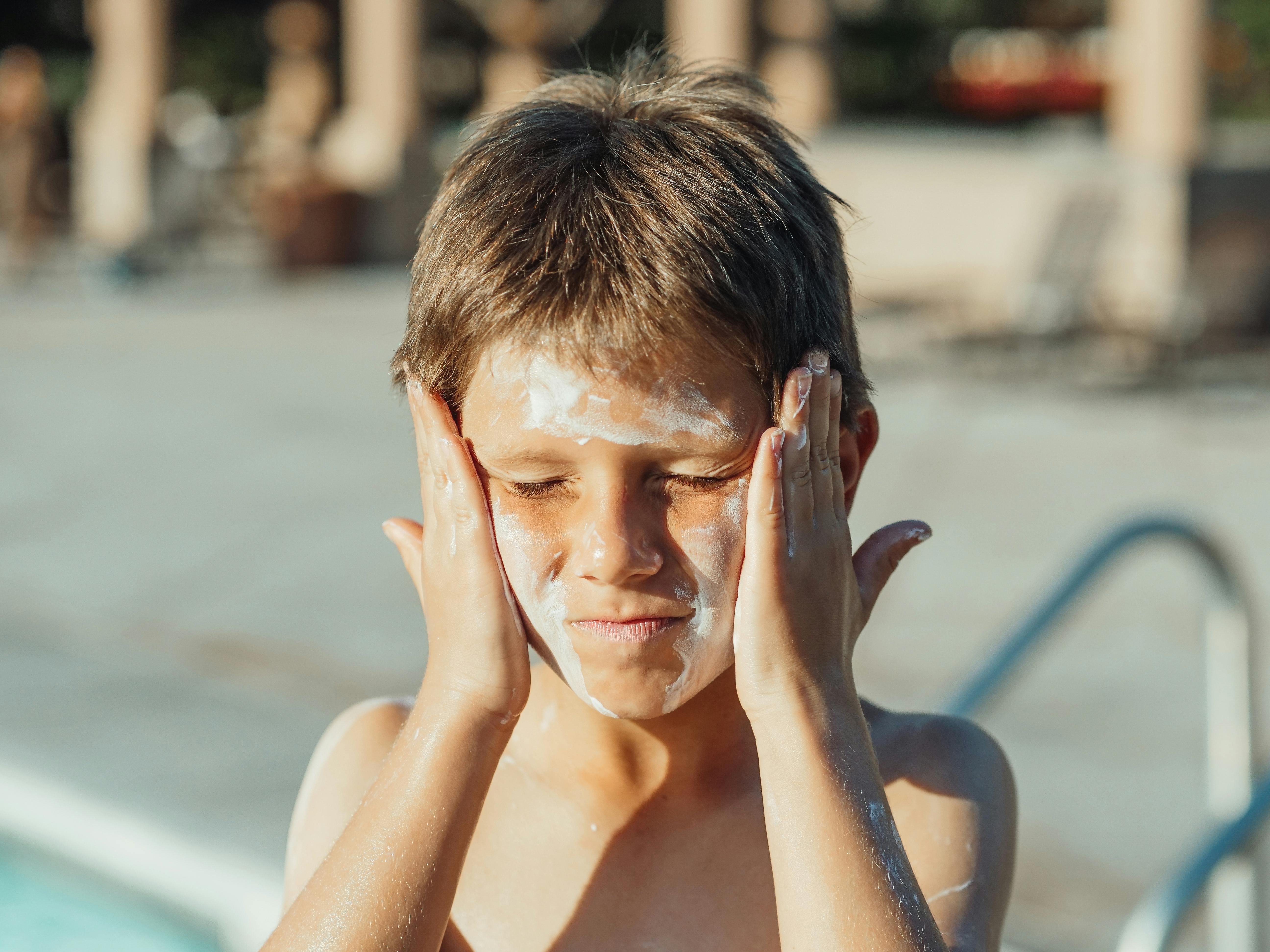 boy applying suncreen