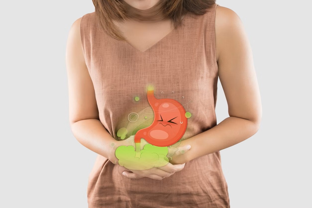 person with stomach ache and flatulence hand on stomach