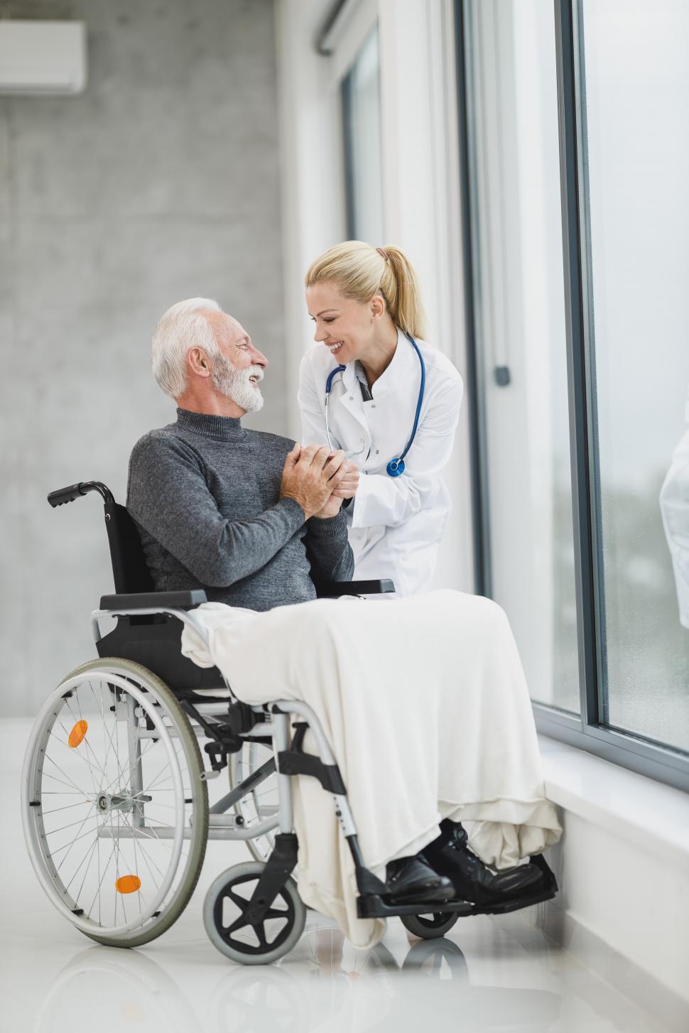 old person in a wheelchair with a doctor taking advise