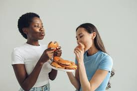 two women eating cheeseburger