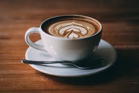 cup of coffee with leaf drawing