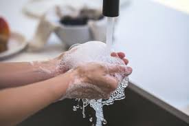 washing hands in the sink with soap