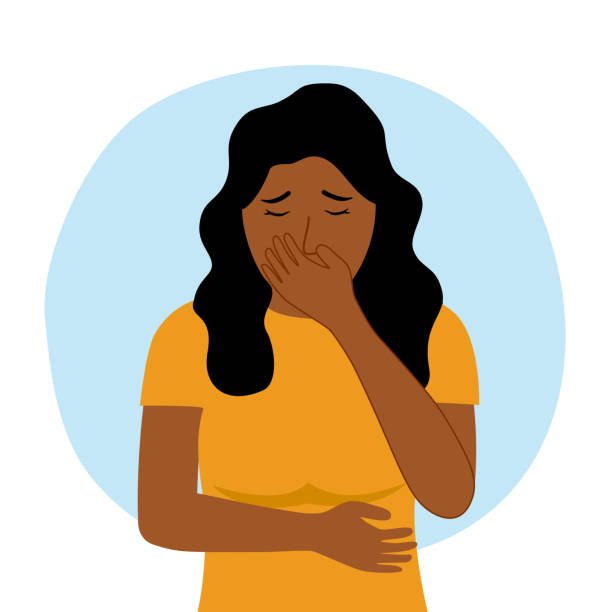 person holding stomach with yellow tshirt feeling like vomiting