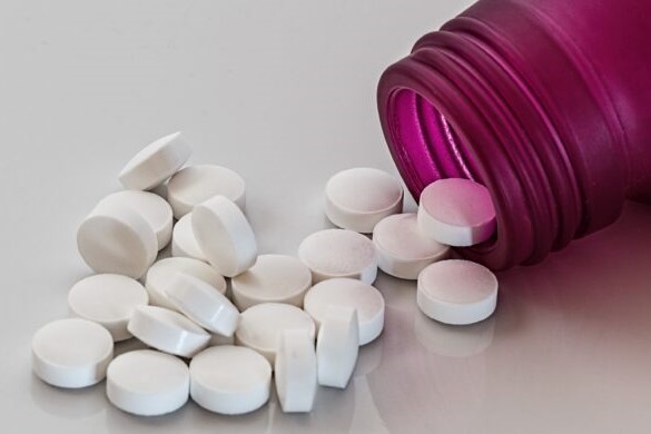 medicine bottle with pills pouring out 