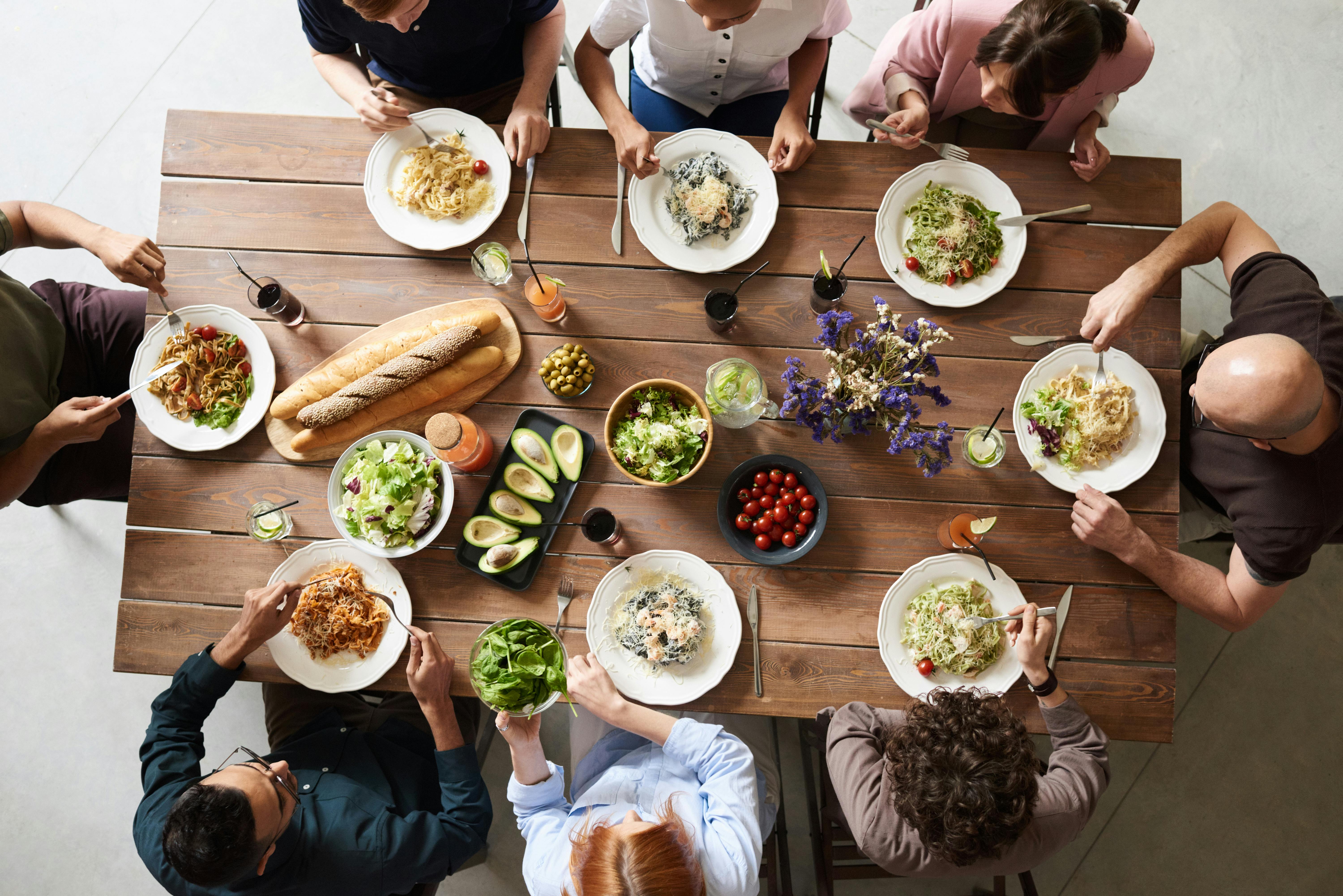 table of food and people eating