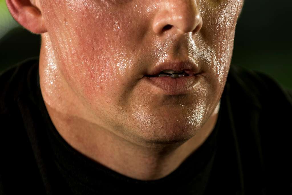 man with sweat pouring out of his face