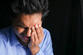 man holding his eye