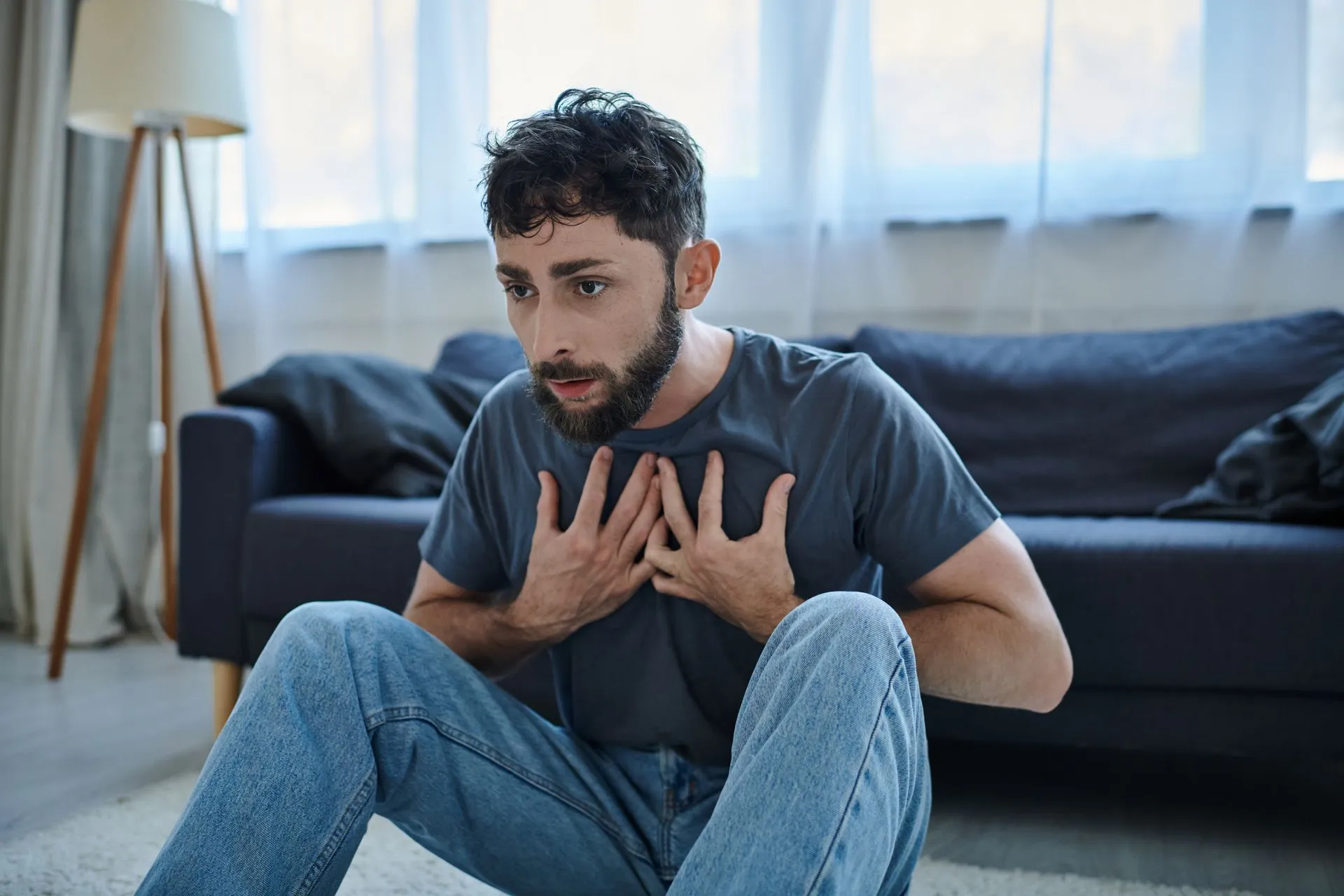 man sitting on floor experiencing panic disorder