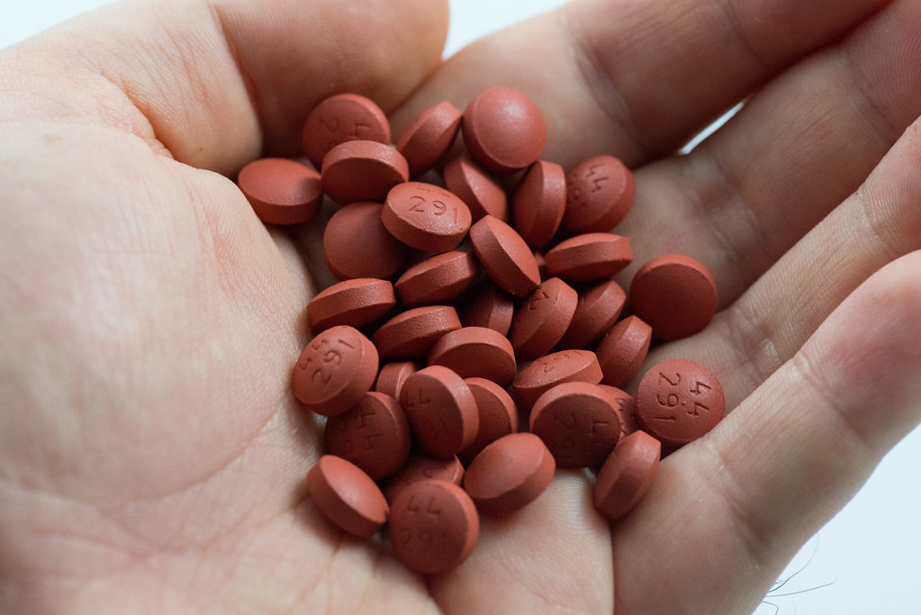 red tablets in palm holding up