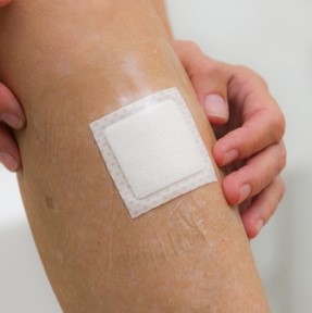 wound dressing on arm