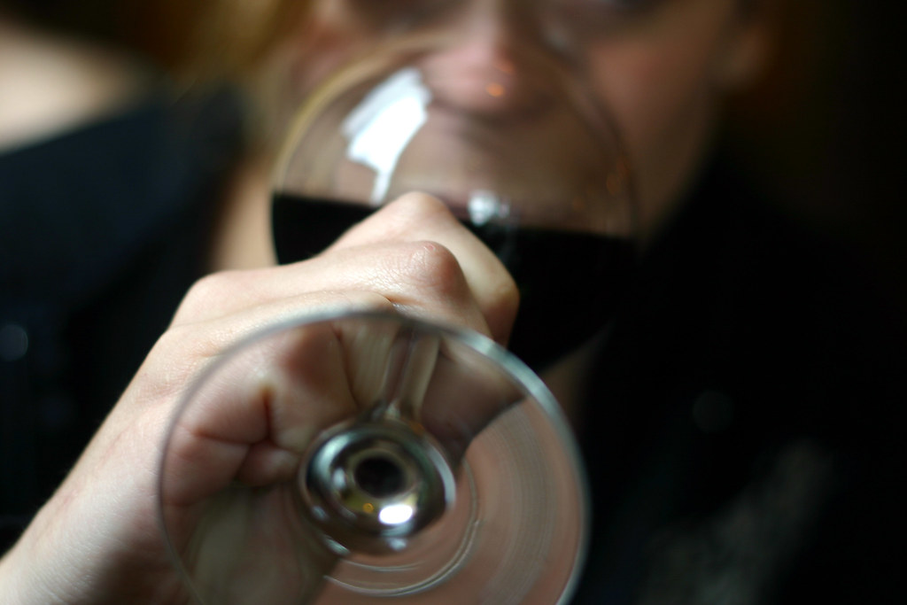 man drinking wine from a glass