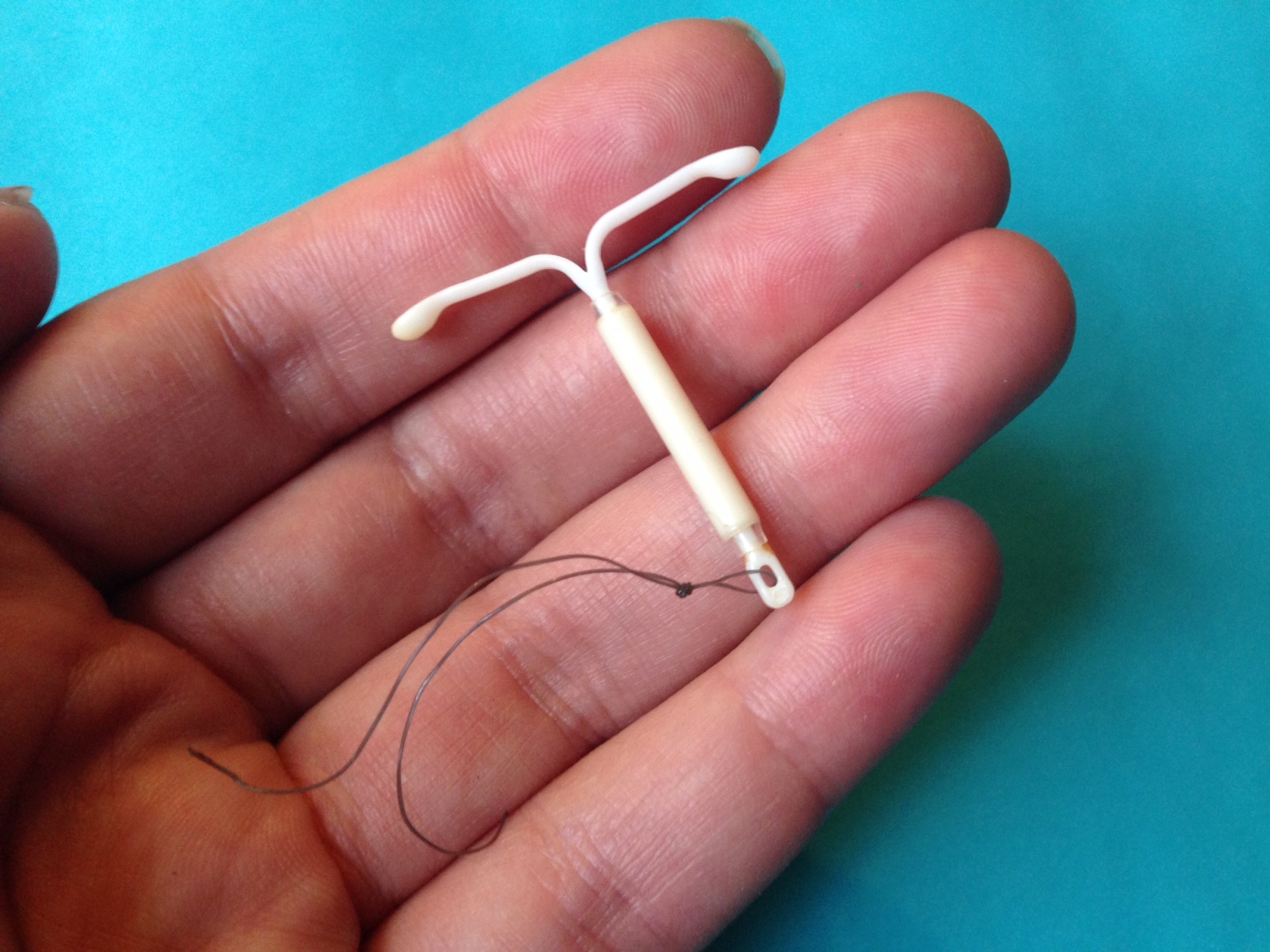 white IUD on top of hand