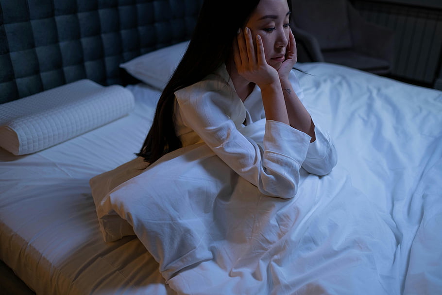 girl sitting on a bed