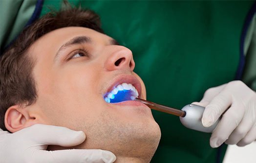 patient with dentist mouth open 