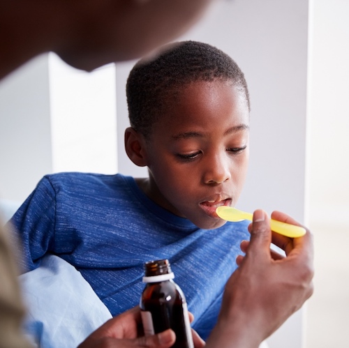 children drinking liquid medicine