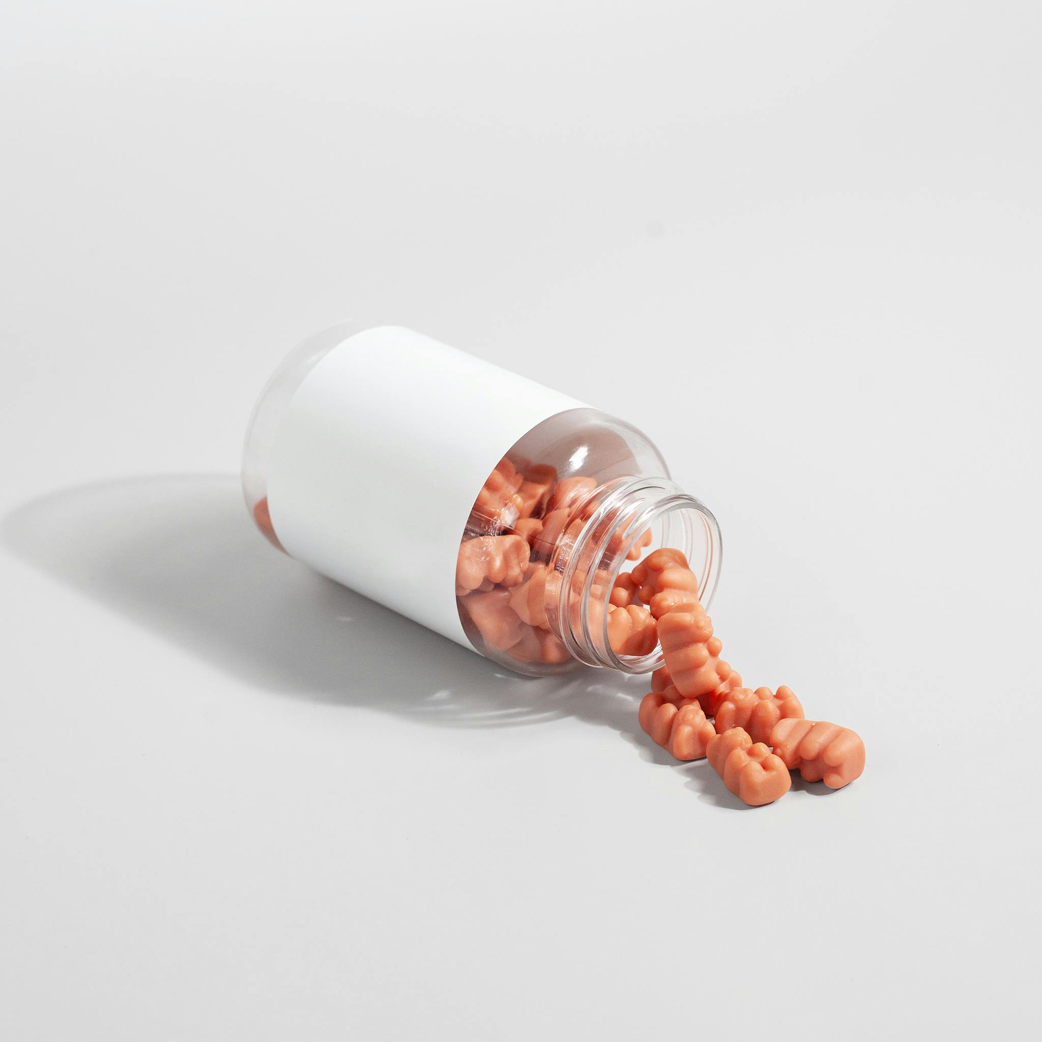 chewable supplement in bottle pouring out on table