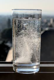 tablet dissolving in a glass of water