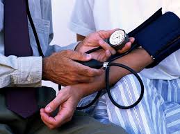 checking blood pressure using blood pressure machine on arm