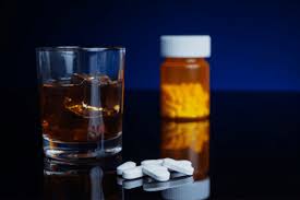 alcohol glass with tablets and blister pack