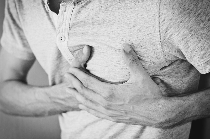 person holding chest, hands on chest chest pain