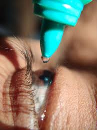 putting eye drops in right eye