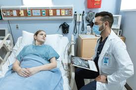 doctor meeting patient in hospital bed