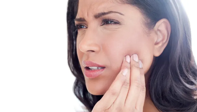 jaw pain woman holding her jaw