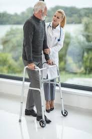 elderly man walking with doctor