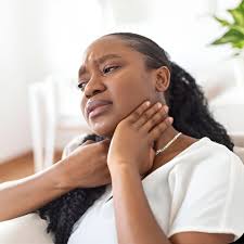 woman with hands on throat itching
