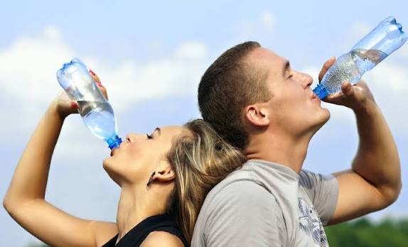 man and woman drinking water 