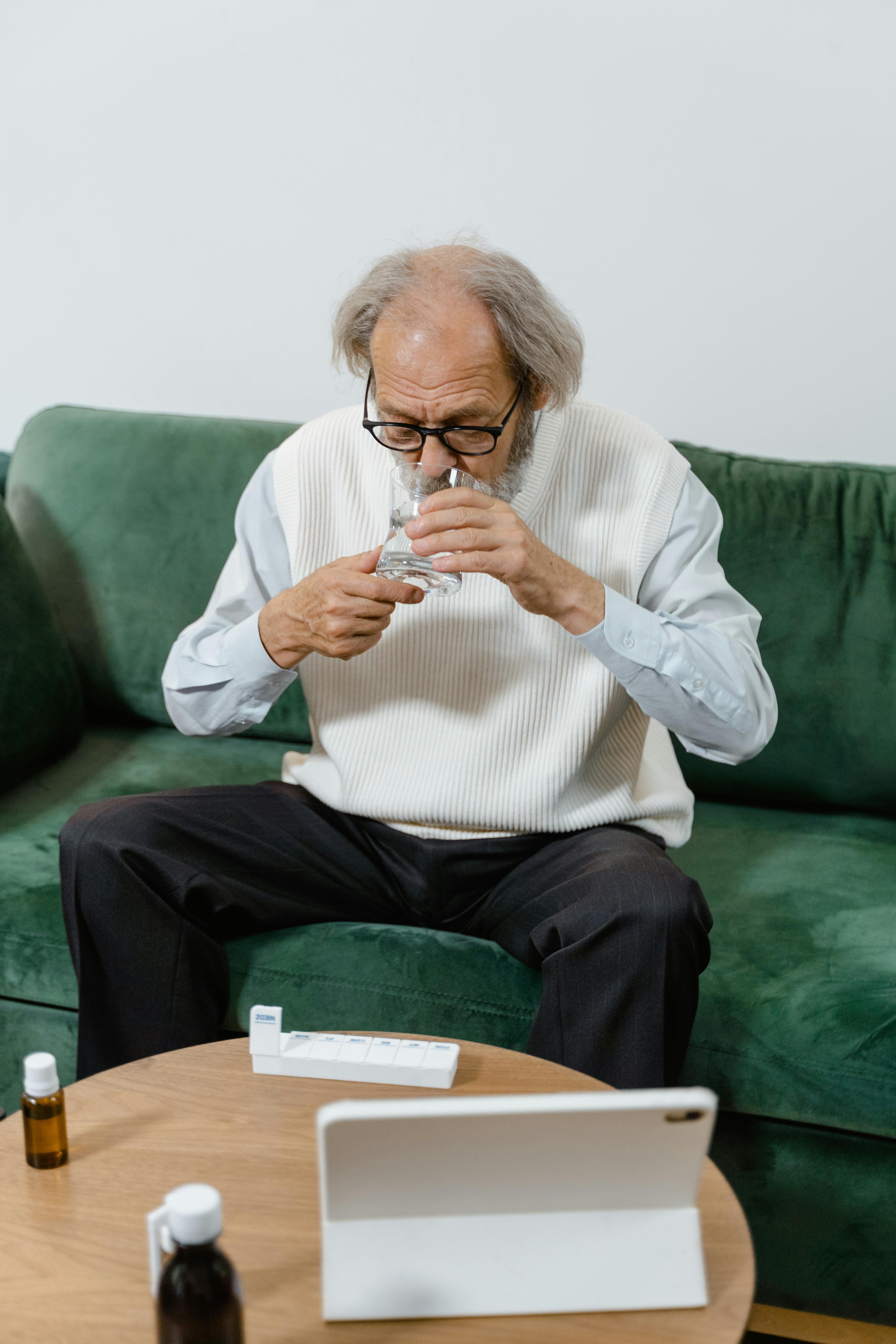Old Man taking Medicine